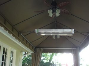 Under a patio shade awning with dark awning fabric