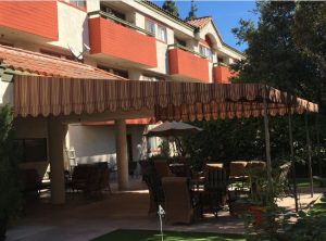 Red and yellow striped awning fabric on a patio shade awning