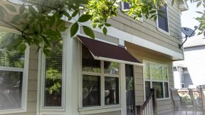 Sol-Lux smart awning window cover with maroon awning fabric